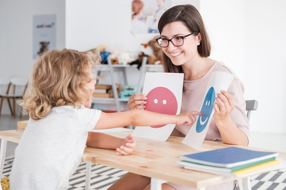 Therapist doing autism therapy with child